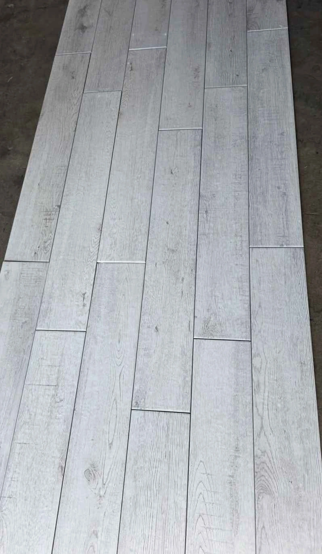 A photo of light grey Wood look tile